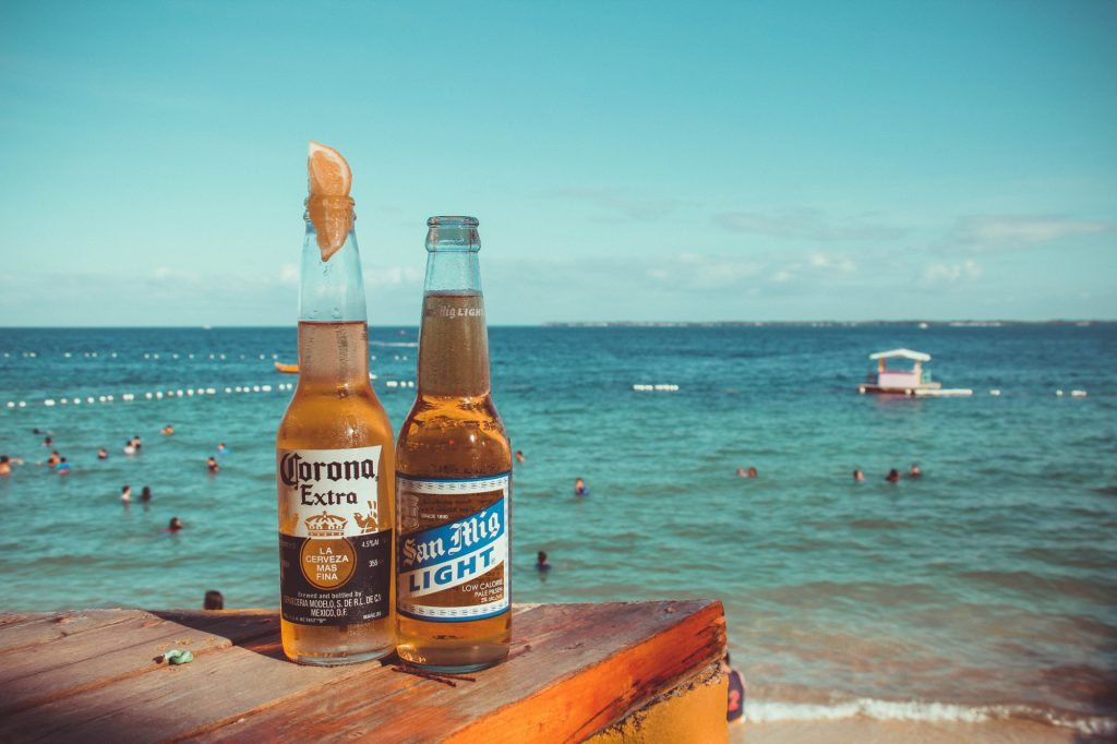 Mexican beers with a beach in the background.